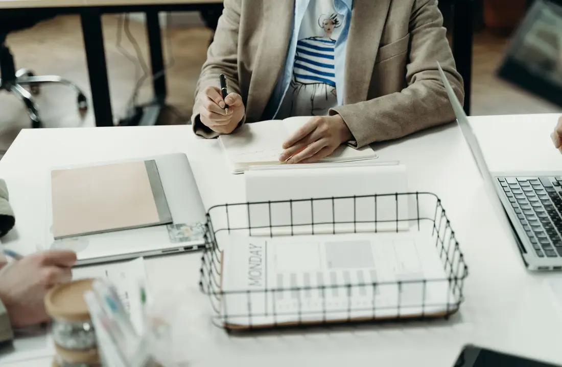 Professional office setting with a focus on planning and note-taking.