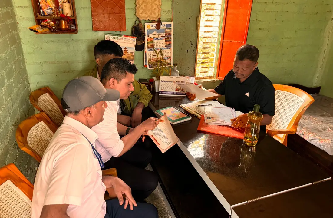 Men working together in a cozy office space with documents and calendars visible.